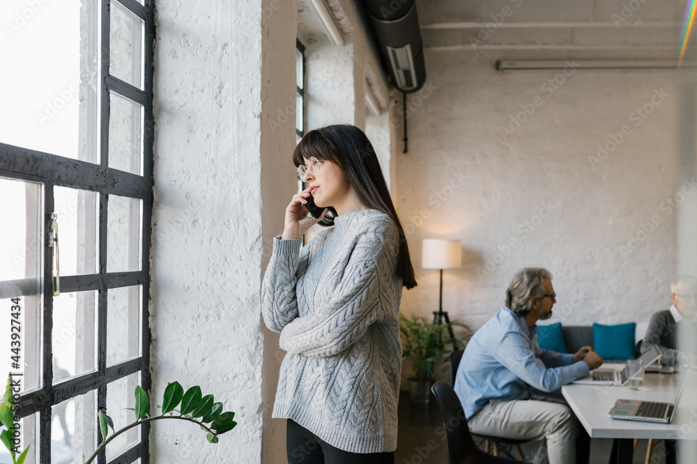 Portrait of a young businesswoman using her smartphone in the office Portrait of a young businesswoman using her smartphone in the office