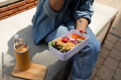Top view of woman having healthy lunch at street