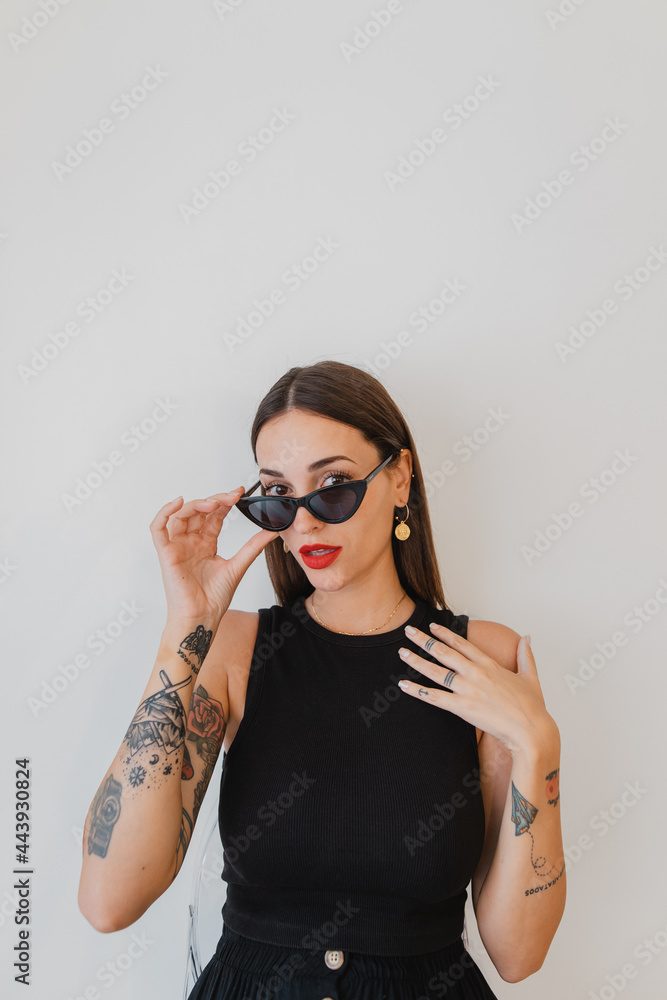 Portrait of woman with tattoos and sunglasses Portrait of woman with tattoos and sunglasses