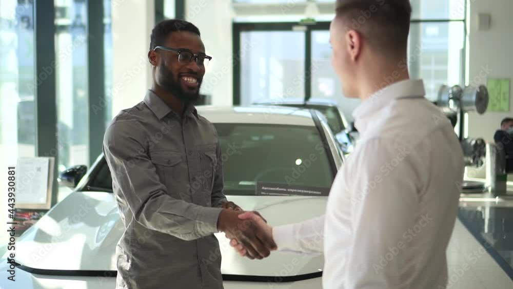 Car purchase in dealership black man shakes salesman hand Spbd Car purchase in dealership black man shakes salesman hand Spbd