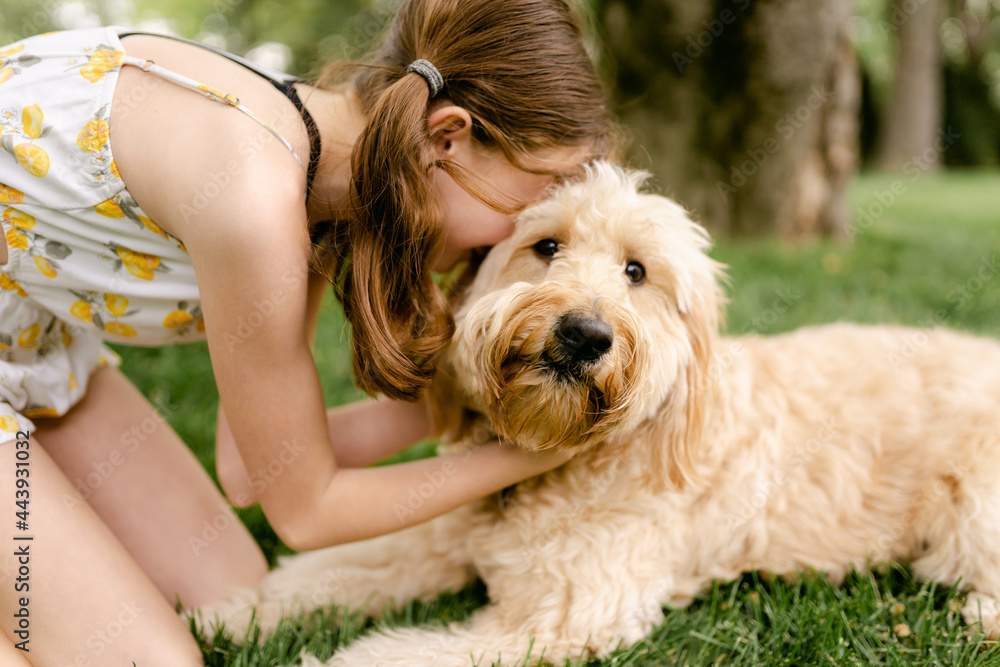 tween girl snuggling her adorable dog tween girl snuggling her adorable dog