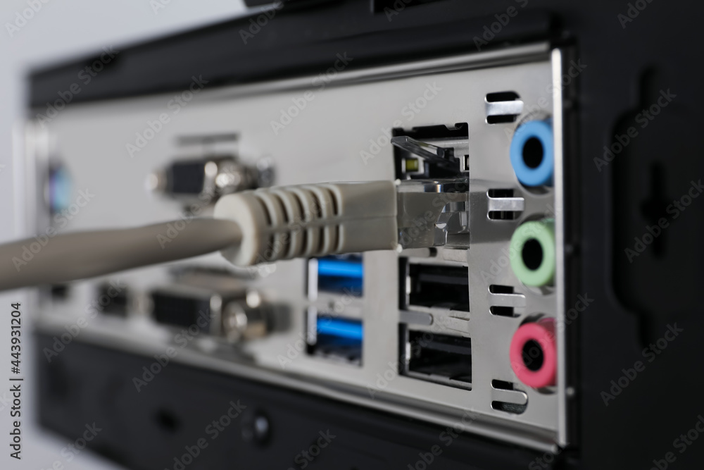 Connected cable to computer system unit, closeup. Internet communication