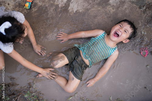 Asian boy playing mud photo