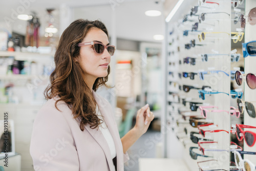 Elegant woman shopping for glasses photo