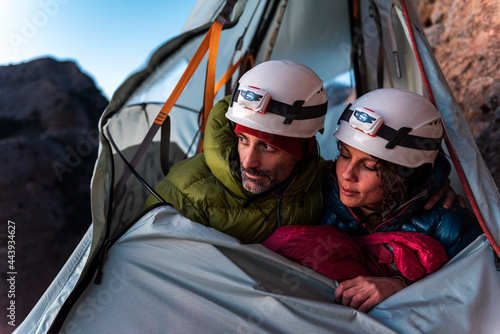 Climbers with safety helmets inside a wall tent