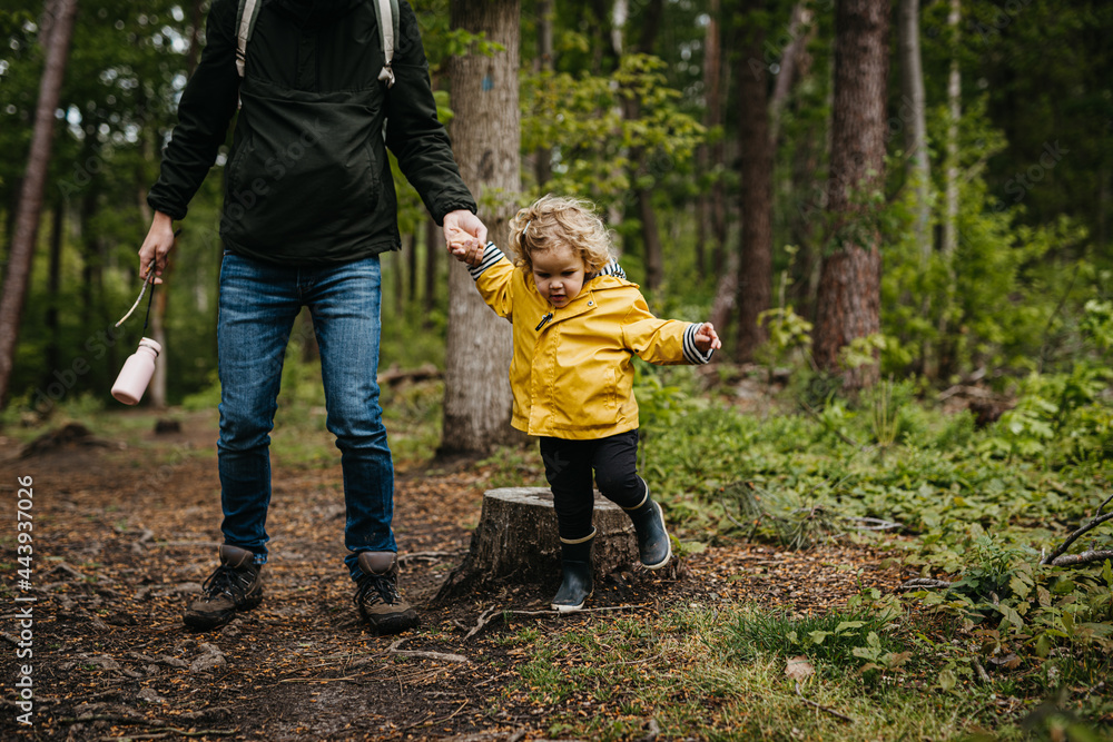 Father exploring forest with daughter on a rainy day Father exploring forest with daughter on a rainy day