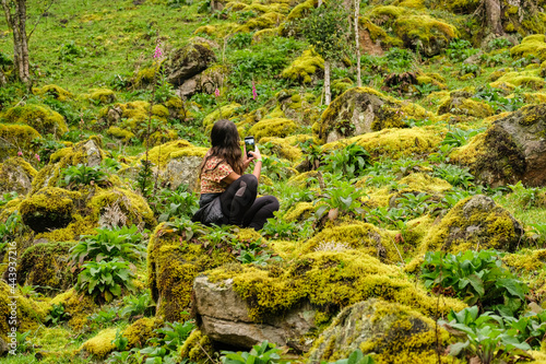 Woman taking a picture in wonderful place, La Chorrera, Choachi, Colombia.