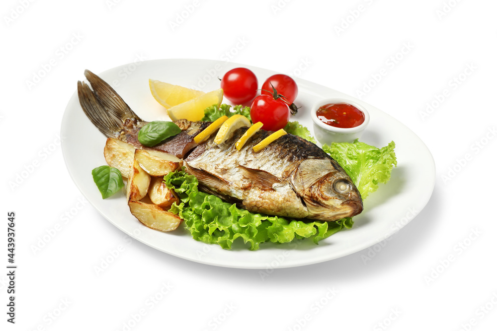 Tasty homemade roasted crucian carp with garnish on white background. River fish Tasty homemade roasted crucian carp with garnish on white background. River fish