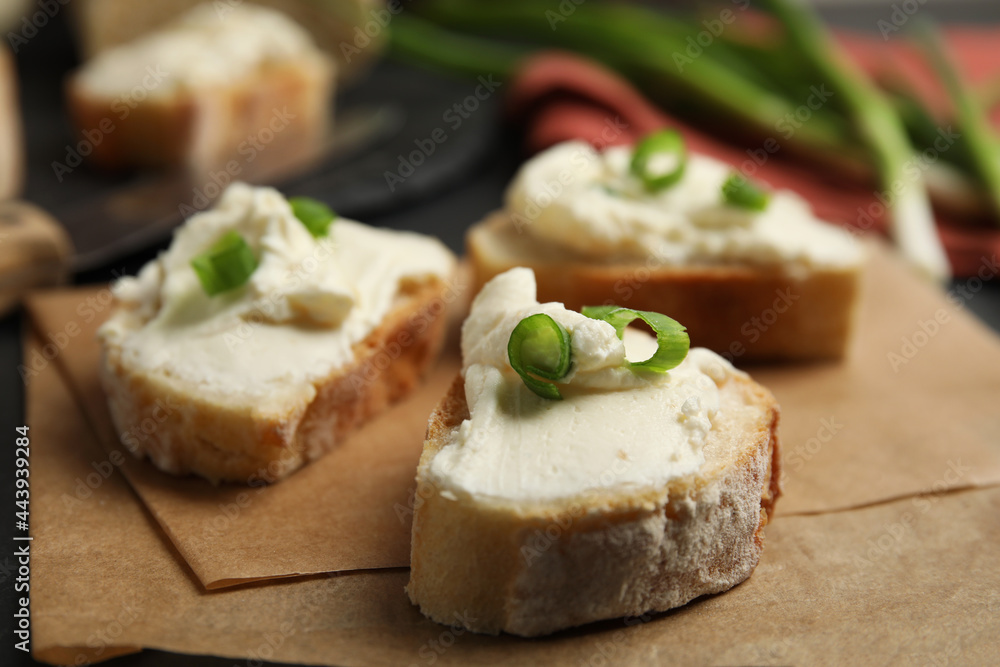 Bread with cream cheese and green onion on table, closeup Bread with cream cheese and green onion on table, closeup