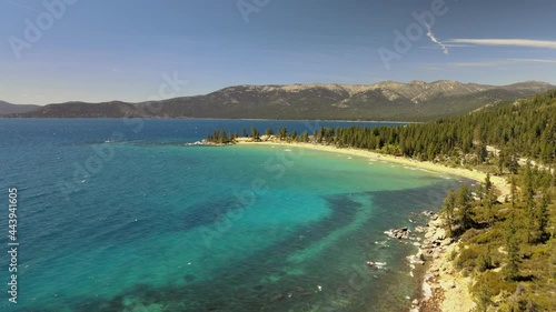 Drone flying over popular Sand Harbor and Sand Point, Nevada. Lake Tahoe. While looking down at the clear water and rocks down below the surface. photo