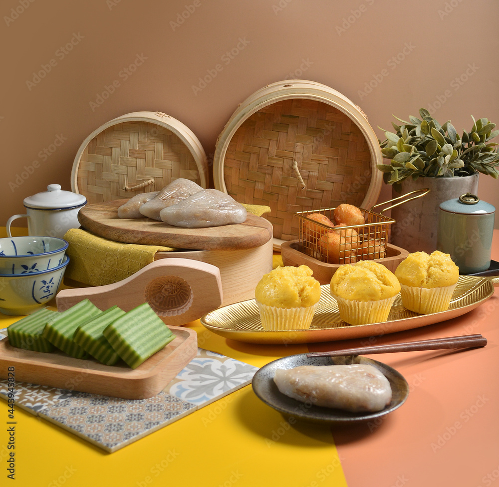 asian traditional snack and dessert in teochew rice, nonya cake, malay kueh and chinese style dim sum group celebrate party menu in Pantone colorful yellow orange brown background and bamboo basket
