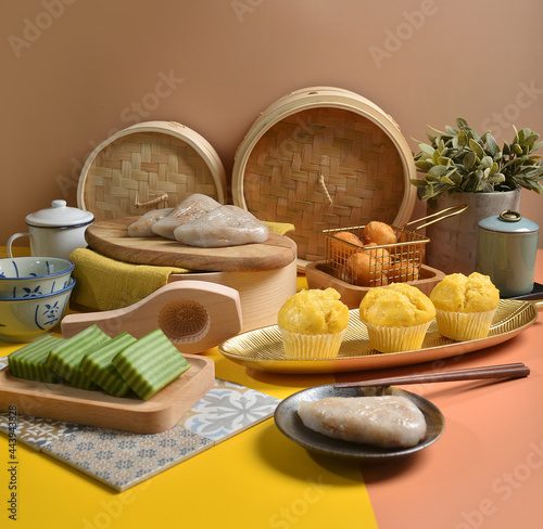 asian traditional snack and dessert in teochew rice  nonya cake  malay kueh and chinese style dim sum group celebrate party menu in Pantone colorful yellow orange brown background and bamboo basket