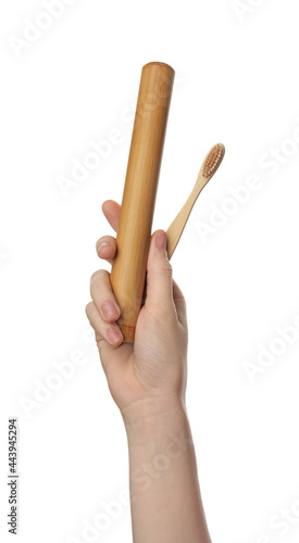 Woman holding eco friendly bamboo toothbrush and case on white background, closeup. Conscious consumption