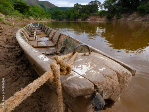 landscape of mountains and river with a fisherman boat photo