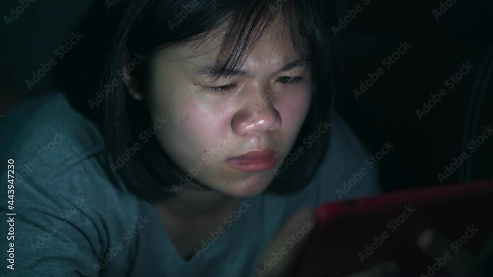 B roll of Asian girl using smart phone or mobile playing games on sofa at home. Young woman using mobile phone on sofa at night. Mobile addiction or insomnia. Young people is phone addiction problem. B roll of Asian girl using smart phone or mobile playing games on sofa at home. Young woman using mobile phone on sofa at night. Mobile addiction or insomnia. Young people is phone addiction problem.
