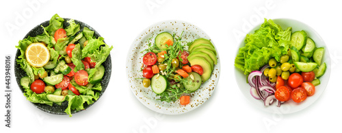 Plates with different healthy salads on white background