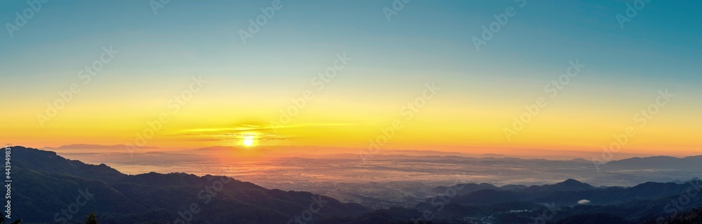 Fototapeta premium Sunrise landscape panoramic view with the sun and misty at Chiang Rai province northern of Thailand