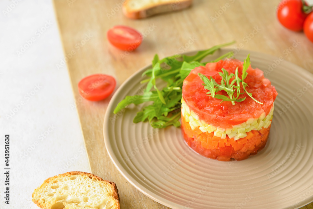 Plate with tasty tartare salad and toasted bread on light background, closeup