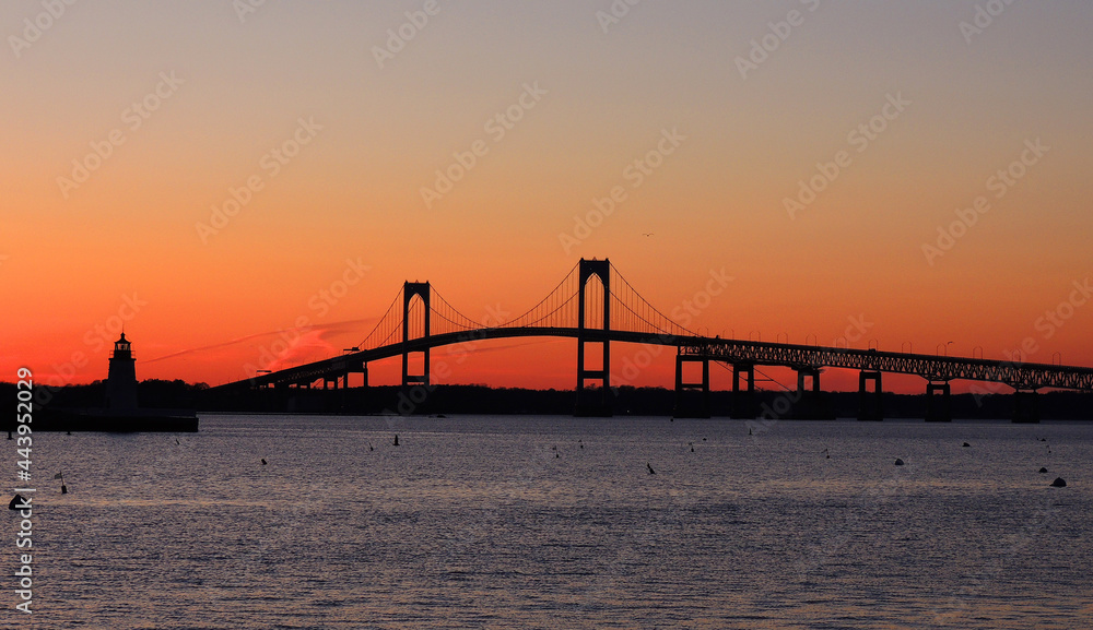 the claiborne pell newport bridge from jamestown to newport,  rhode island, over narragansett bay, with a spectacular sunset