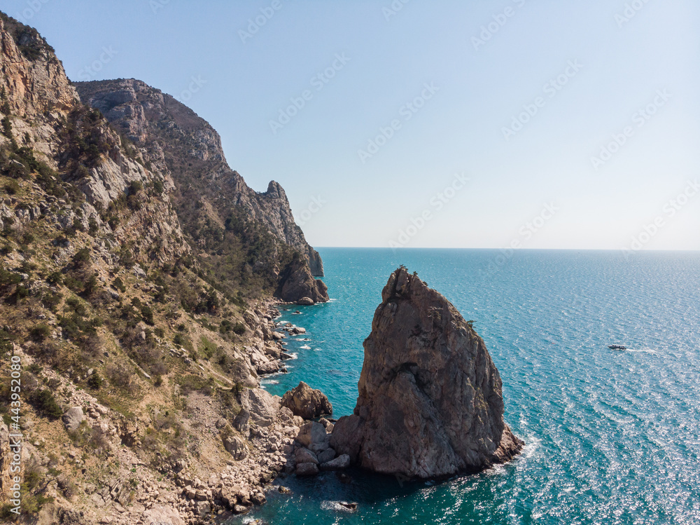 Naklejka premium High cliffs and calm sea. Calm. Warm sunny summer day. Rest abroad. View from above