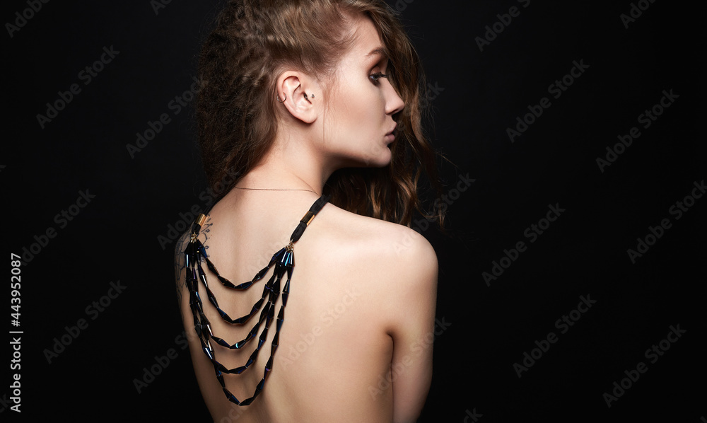 beautiful young woman with necklace on her naked back beautiful young woman with necklace on her naked back