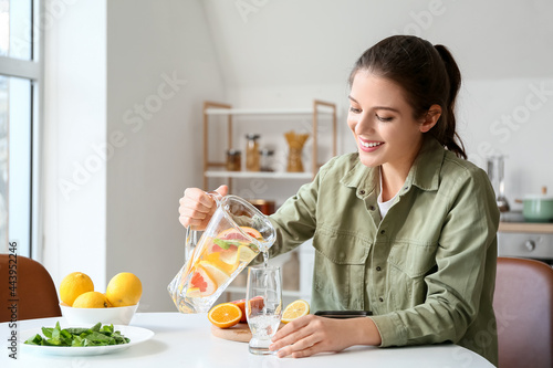 Young woman drinking fresh ...