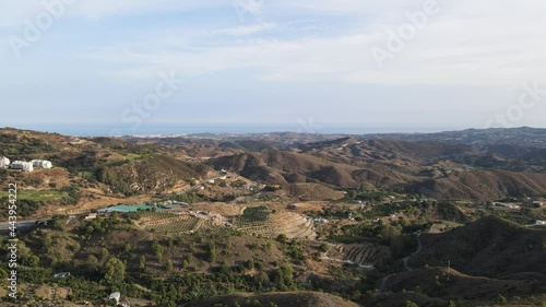 Aerial view agricultural fields against hills and Alboran sea, Alhaurin el Grande, Malaga, Spain photo