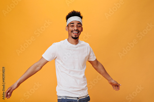 Valokuva Portrait of funny guy in headband and white t-shirt