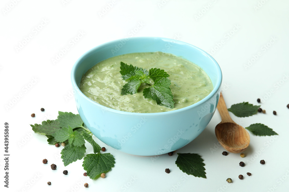 Concept of healthy food with nettle soup on white background Concept of healthy food with nettle soup on white background