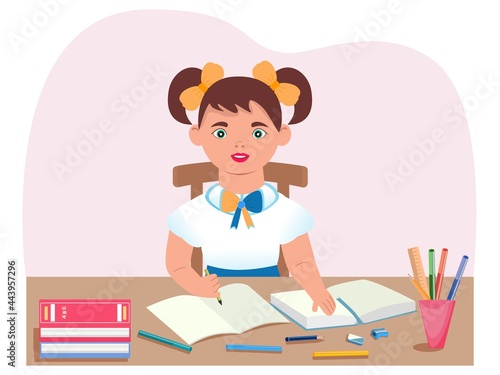 The schoolgirl is sitting at her desk. The concept of raising children in schools. Teaching children foreign languages, literature, writing, mathematics, history, physics, chemistry, geography.
