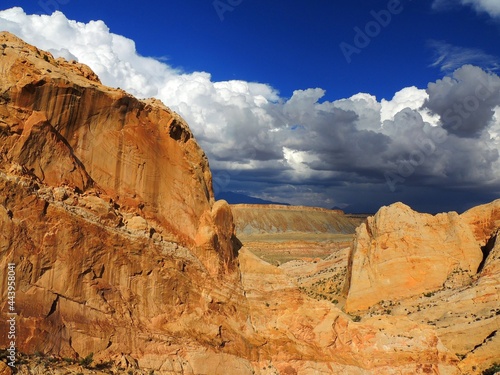   the  steep red rock formations of burr trail on a sunny day near capitol reef park in  central utah  photo