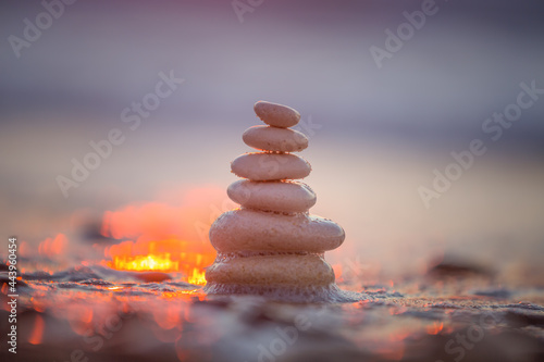Stones balance on the beach and color sunrise. Zen meditation and relaxation