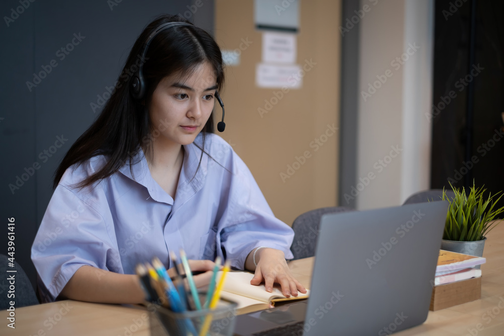 E-learning ,online ,education and internet social distancing protect from COVID-19 viruses concept. Asian woman student video conference e-learning with teacher on laptop computer at home. E-learning ,online ,education and internet social distancing protect from COVID-19 viruses concept. Asian woman student video conference e-learning with teacher on laptop computer at home.