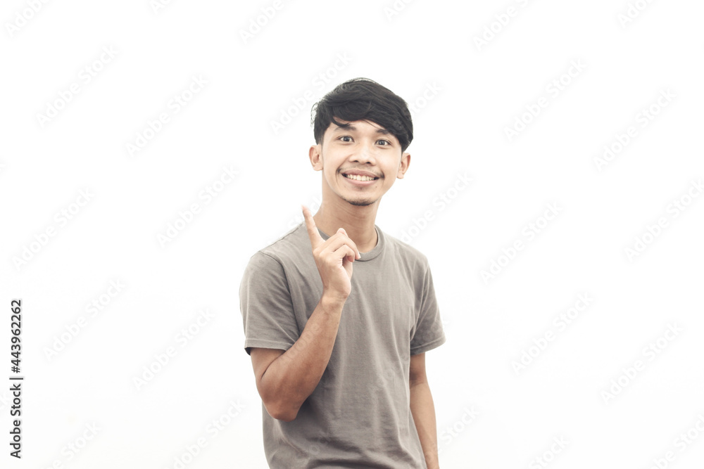 portrait of asian youth wearing gray t-shirt with pointing expression portrait of asian youth wearing gray t-shirt with pointing expression