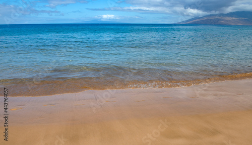 Calm sea beach background. Summer tropical beach with sand. Ocean water. Natural seascape.