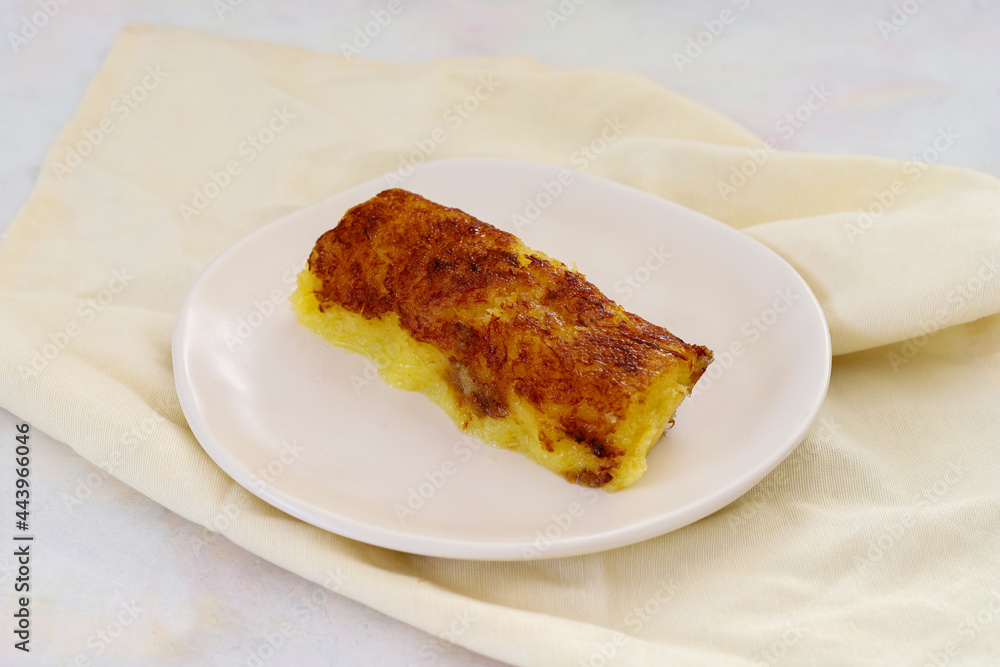 cheese dessert on a white wooden background. Local name peynir tatlisi cheese dessert on a white wooden background. Local name peynir tatlisi