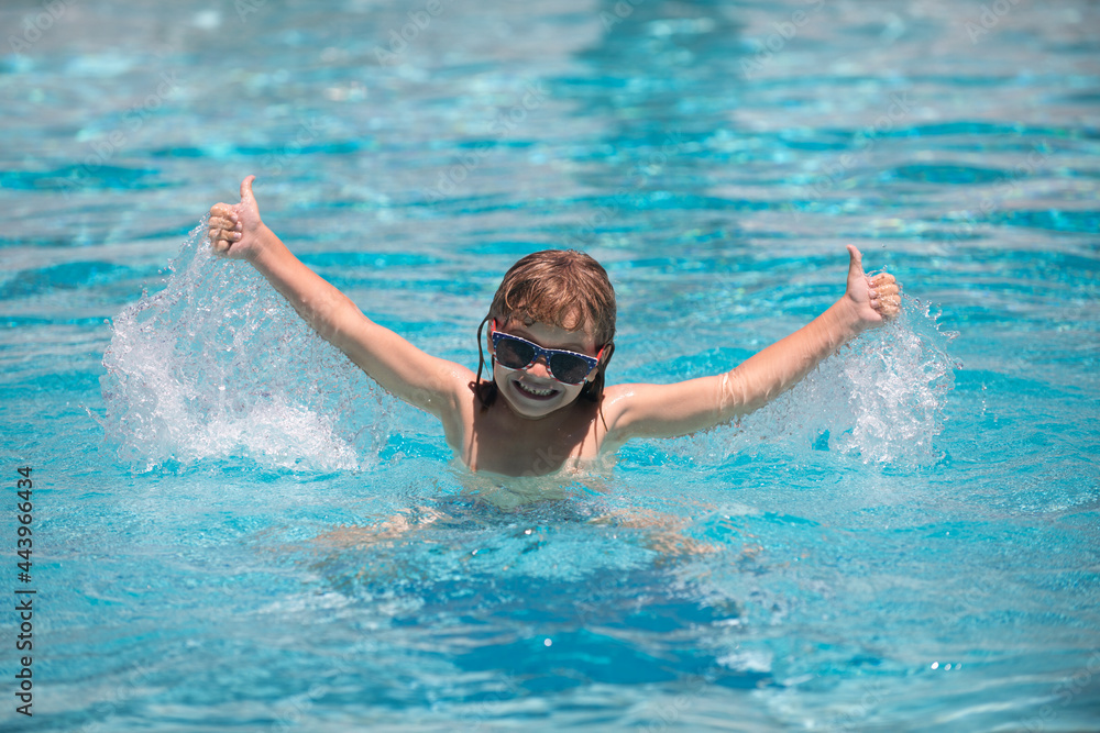 Splash water. Child relax in summer swimming pool splashing in water having fun leisure activity raised hands.