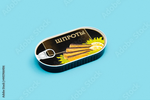 Tinned sprats in a jar on a colored background шпроты