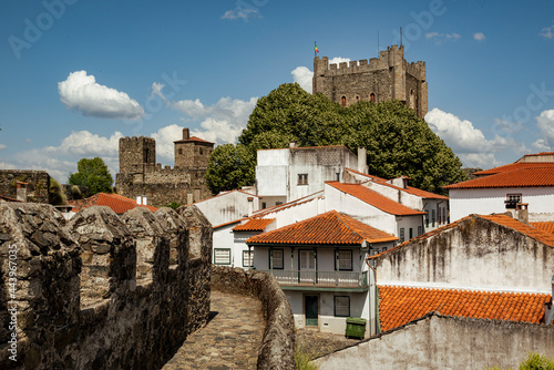 View towards the tower of „Castelo de Bragança“ castle surrounded by white houses with red rooftops, Bragança district, Montesinho, Portugal photo