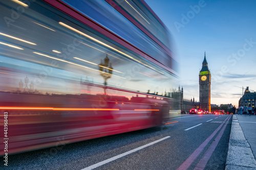 Red double-decker bus on Westminster Bridge at night, London, Great Britain	