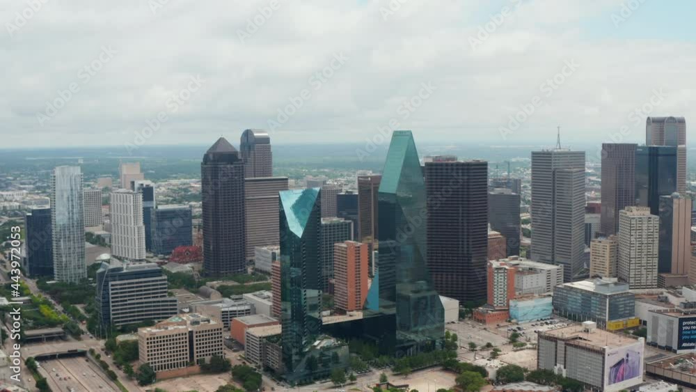 Forwards reveal of modern tall buildings at Fountain place with glass facades and irregular shape. Aerial view of downtown. Dallas, Texas, US. Forwards reveal of modern tall buildings at Fountain place with glass facades and irregular shape. Aerial view of downtown. Dallas, Texas, US.