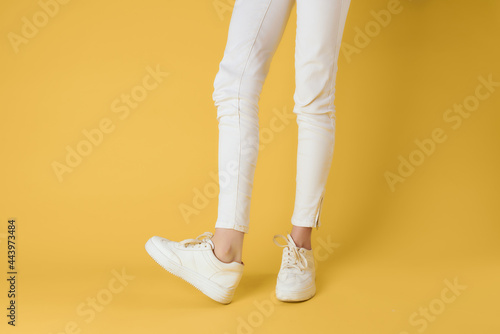 white womens sneakers posing street fashion cropped view isolated background