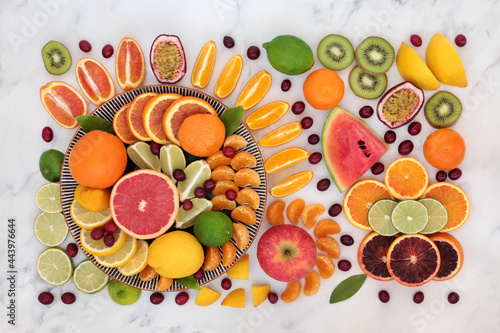 Tropical & citrus fruit for immune system boost high in antioxidants, fibre, anthocyanins, lycopene, vitamins & minerals. Natural healthcare concept.  Flat lay on marble.