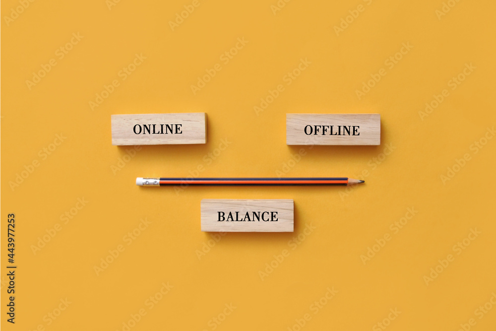 Wooden plate in the form of scales with inscriptions: online and offline. A symbol of the balance between online and offline in life Wooden plate in the form of scales with inscriptions: online and offline. A symbol of the balance between online and offline in life