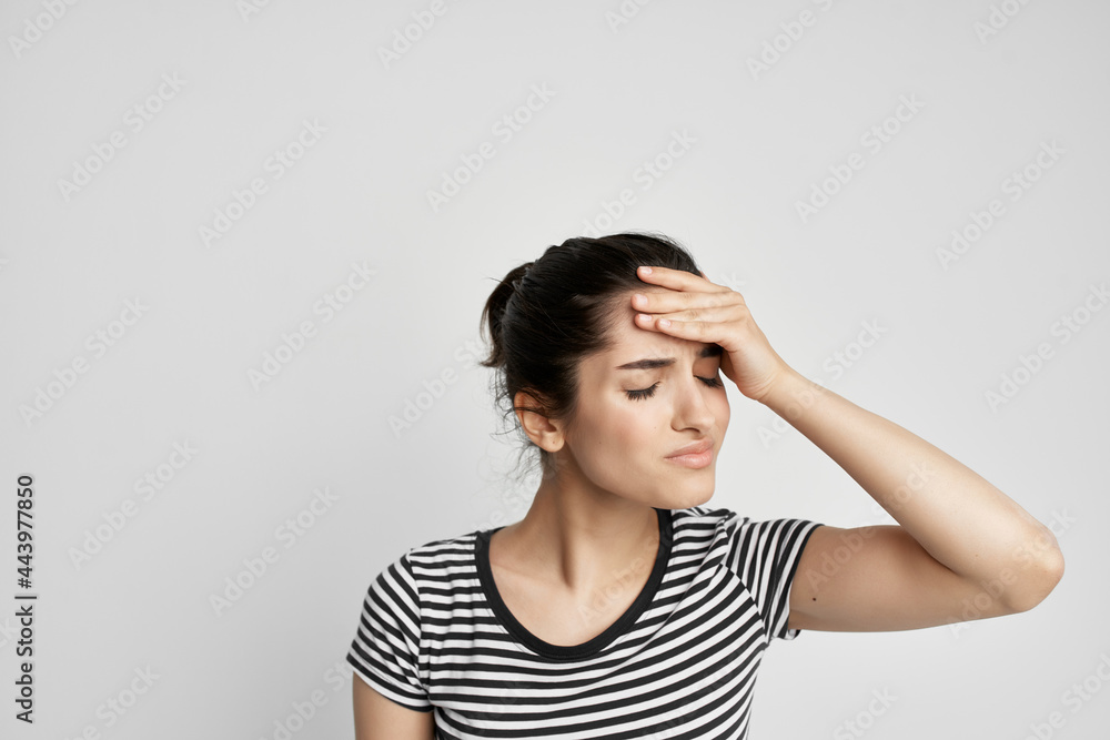 woman with unhappy facial expression holding her head migraine pain woman with unhappy facial expression holding her head migraine pain