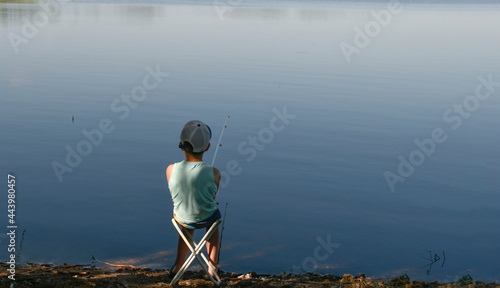 A boy on a fishing trip. A lonely fisherman. Fishing on the lake. Fishing with a fishing rod. Bite.