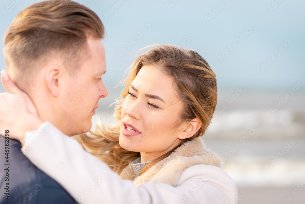 Two Young couple standing enjoying on a coast and enjoying each other.Summer,spring,autumn vacation.Closeup. Two Young couple standing enjoying on a coast and enjoying each other.Summer,spring,autumn vacation.Closeup.