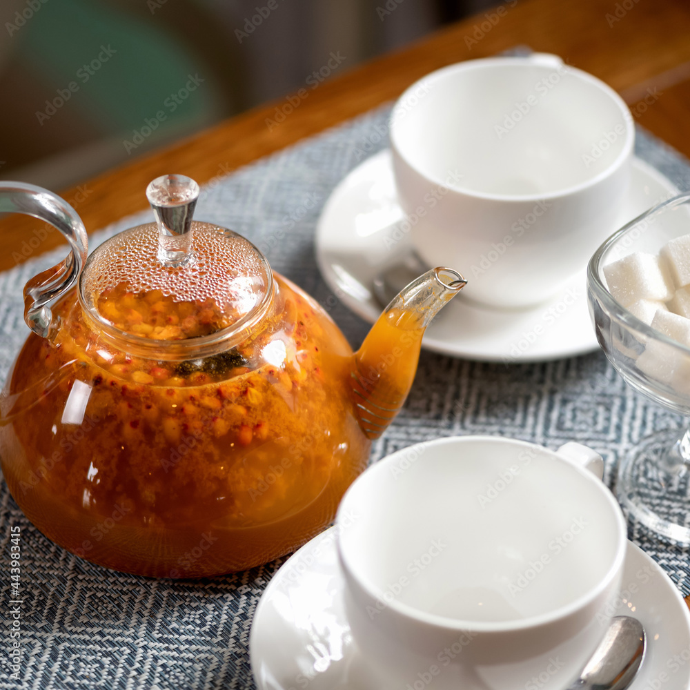 Hot orange drink, Sea buckthorn tea. Natural energy Berry beverage, prevention of flu and colds in autumn-winter season. Hot orange drink, Sea buckthorn tea. Natural energy Berry beverage, prevention of flu and colds in autumn-winter season.