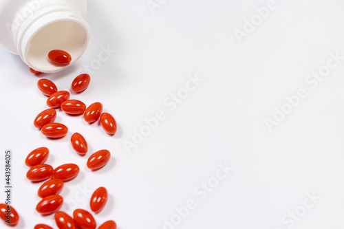 Orange capsules of lutein on a white background with place for text. Supplements and herbal medicine, homeopathy, treatment and prevention photo