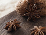 Star anise and walnuts on a wooden background